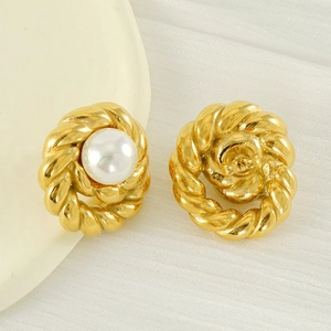 Vintage gold twisted rope stud earrings with central white pearls on a white fabric