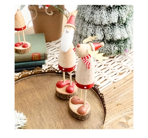Close-up of wooden Santa and Reindeer ornaments on a vintage tray with warm decor