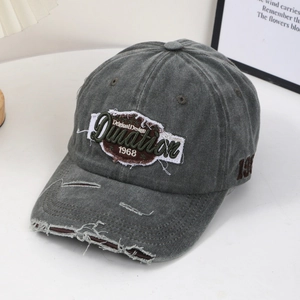 Detail of vintage washed gray baseball cap with distressed brim and 1968 embroidery