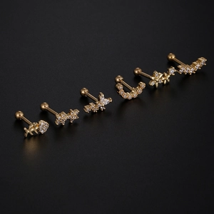 Detailed macro view of gold screw-back cartilage studs with cubic zirconia in six shapes