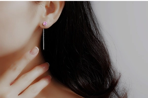 Detail of S925 silver threader earrings featuring a faceted pink zircon and long tassel chain