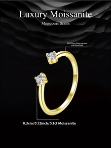 Detail of s925 silver gold-plated ring with two 0.1ct moissanite stones on black background