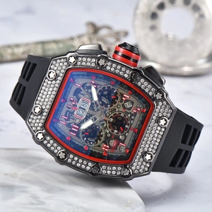 Macro shot of tonneau-shaped watch dial with skeleton design and red details