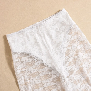 Macro detail of high-elastic white lace fabric with intricate floral embroidery patterns