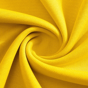 Close-up of bright yellow pique knit fabric texture with breathable mesh structure