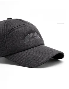 Detail of gray baseball cap featuring white embroidery and fine twill fabric texture