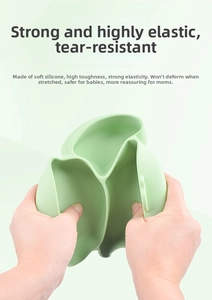 Close-up showing the high elasticity and flexibility of the mint green silicone baby plate