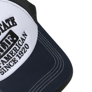 Macro shot of precise black embroidery and parallel stitching on a vintage trucker hat