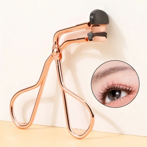 Macro view of rose gold eyelash curler with high-elastic black rubber pad for lash curling