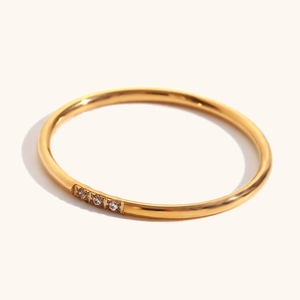 Minimalist 18K gold plated stainless steel ring featuring three micro-set diamonds