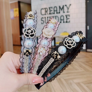 Detail view of lace headbands with pearls, camellia charms and small bee accents
