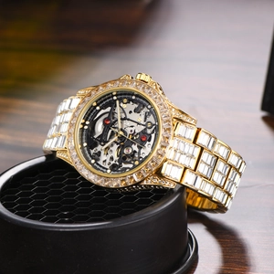Macro view of gold iced-out mechanical watch with skeleton dial on a display stand