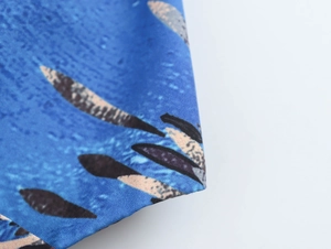 Detailed macro view of the woven blue fabric with black and beige feather patterns