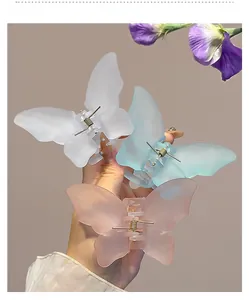 Detail of frosted resin butterfly hair claws in pastel white, blue and pink colors
