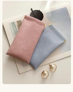 Detail of pink and blue faux leather glasses cases with gold squeeze top closure