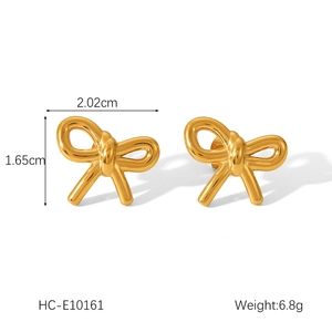 Macro shot of bow earrings in 18k gold finish with detailed size and weight specs