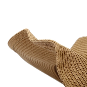 Close-up of a stylish khaki wide-brim straw hat with tight plain weave and wavy edge detail