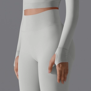 Detailed macro view of seamless ribbed fabric and thumb hole cuffs on light gray gym top