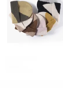 Close-up of thick double-layer knitted beanies in multi-color patchwork colorways