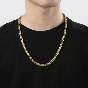 Close-up of a 6mm golden stainless steel Byzantine chain necklace worn by a male model