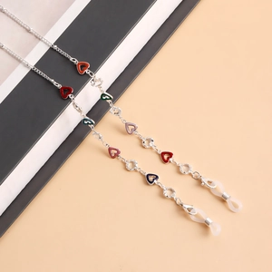 Close-up of multicolor heart charms and crystal beads on a silver eyewear chain
