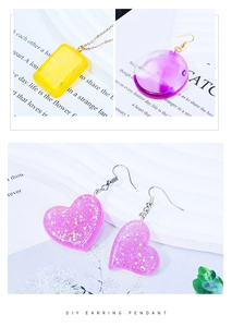 Detail of DIY resin earrings in heart and circle shapes with glitter and gold hooks