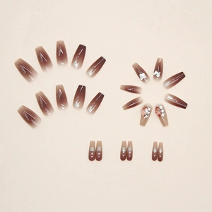 Ombre pink and coffee nails with 3D floral accents, glitter, and luxury rhinestones