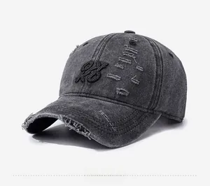 Detail of distressed dark gray washed cotton baseball cap with vintage embroidery
