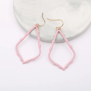 Detail view of pink teardrop hollow earrings with unique painted metallic texture