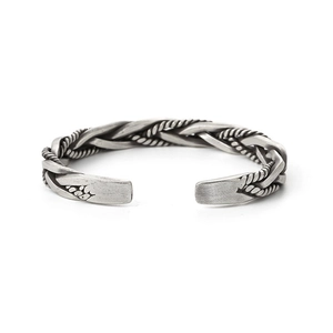 Detailed close-up of a vintage twisted woven metal open cuff bracelet for men and women