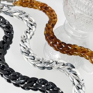 Detail of colorful acrylic chain links in black, marble white, and amber tortoiseshell