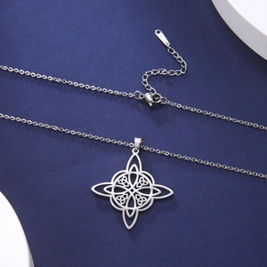 Macro detail of stainless steel Celtic witch knot necklace with lobster clasp on blue background