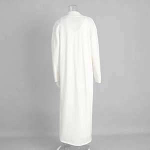 Close-up of long white knit cardigan with textured knit fabric and drop shoulder design