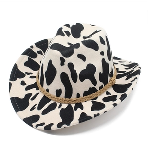Detail of western cowboy hat with cow print pattern and brown braided rope band
