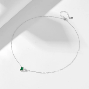 Detail of S925 silver necklace with emerald-cut green stone and pear-shaped white zircon