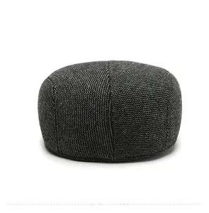 Detail view showing neat stitching on the back of a grey herringbone wool newsboy hat