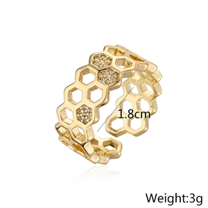 Detail view of gold geometric honeycomb ring with 1.8cm inner diameter and 3g weight
