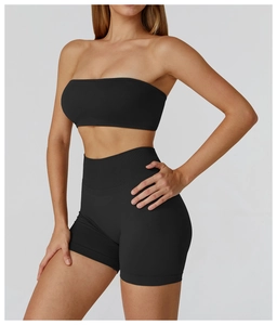 Detail shot of the seamless black tube top sports bra and high waist shorts set