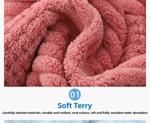 Detail showing the thick pink coral fleece texture and absorbent looped fabric of the towel
