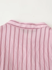 Close-up of pink and red vertical striped fabric texture and neck stitching detail