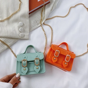 Mini jelly crossbody bags in mint green and bright orange with metallic chains