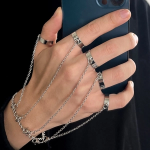Silver punk style multi-finger ring bracelet combo with sleek chains on hand