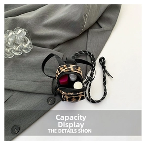 Detailed capacity view of a mini leopard print canvas pouch for lipsticks and accessories