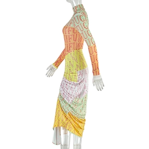 Close-up of high-neck dress with colorful patchwork print and letter details