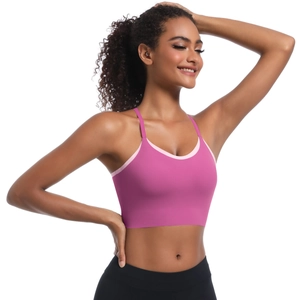Detailed view of magenta and light pink sports bra with cross straps and elastic fabric