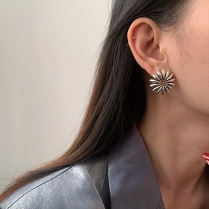 Vintage silver sunflower stud earrings worn by model for a stylish floral aesthetic