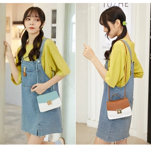 Detail view of stylish color-block crossbody bags in mint green and brown leather finishes