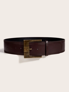 Detail of a dark brown wide belt with decorative stitching and a vintage brass buckle