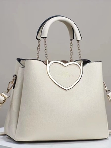 Chic beige faux leather tote bag with heart-shaped gold metal hardware and chain strap