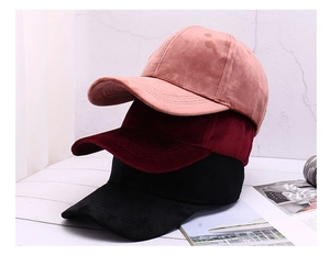 Close-up of premium velvet baseball caps in pink, burgundy, and black soft fabric textures